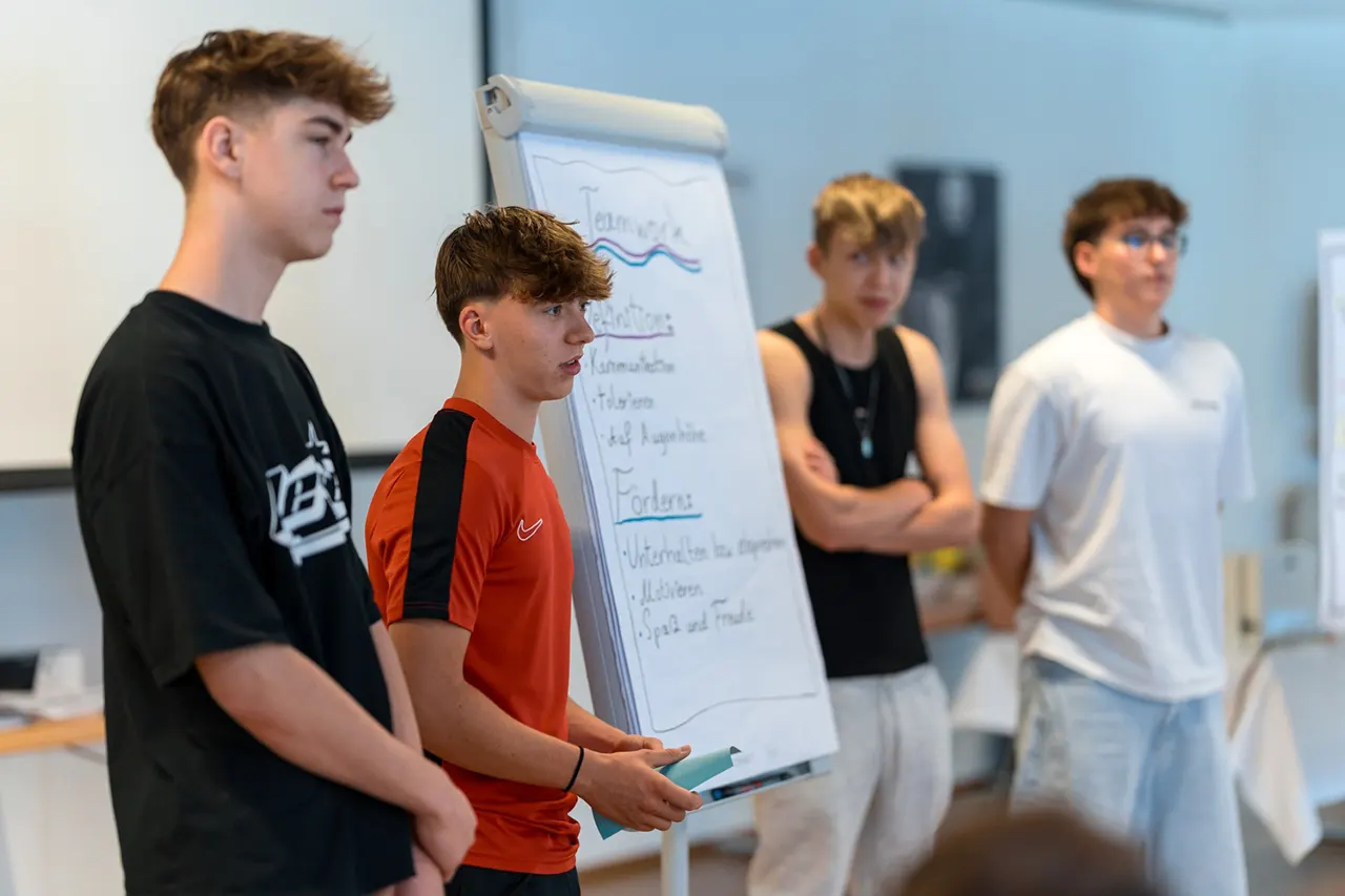 Lehrlinge präsentieren im Rahmen eines Lehrlingsseminars von Lehrlingsimpuls ihre Ergebnisse – Präsentationstraining zur Förderung von Selbstbewusstsein, Ausdruck und Teamarbeit.