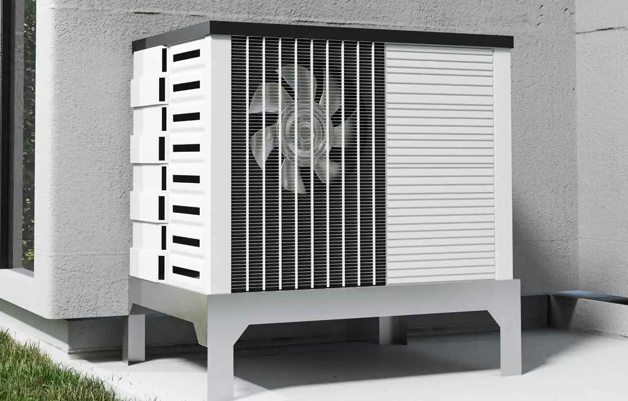 Outdoor air source heat pump unit mounted on a stand beside a house wall with visible fan grille and ventilation panels