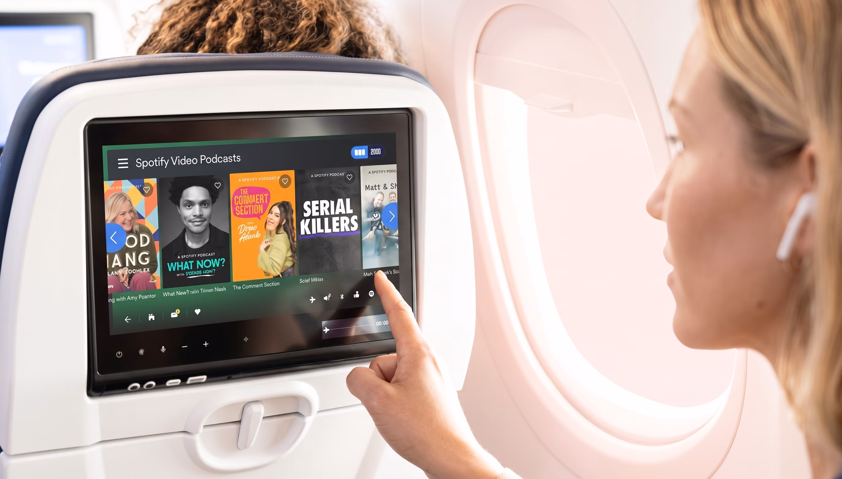 A young woman using a setback screen on a flight