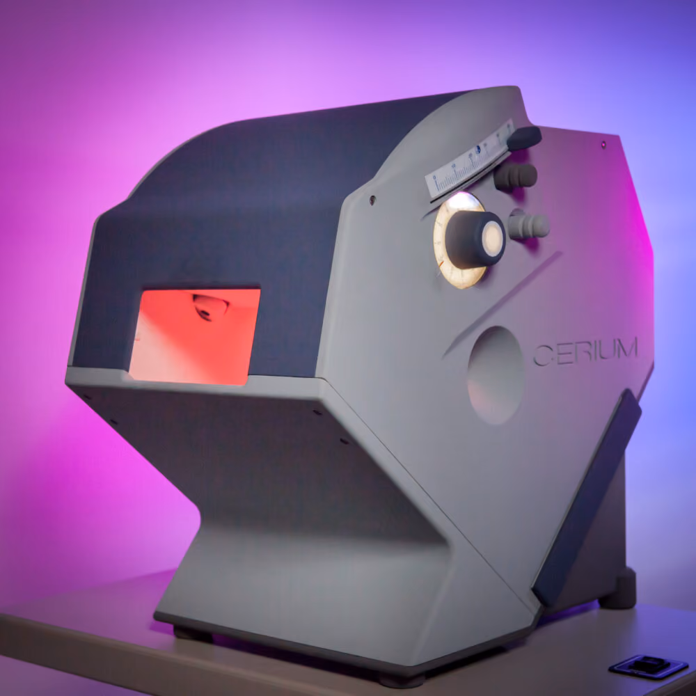 Angular side view of a vintage gray device labeled Cerium, featuring various knobs, a dial with calibration marks, and a red-lit rectangular opening on the front, set against a purple and blue gradient background.