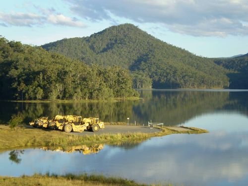Earthmoving scrapers on a boat ramp at golden hour