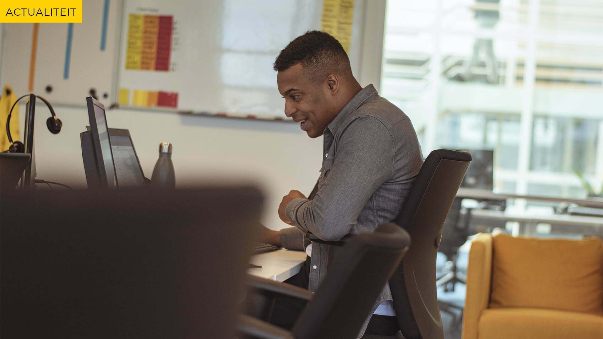 Man at a desk in an office, with the label News in the top left