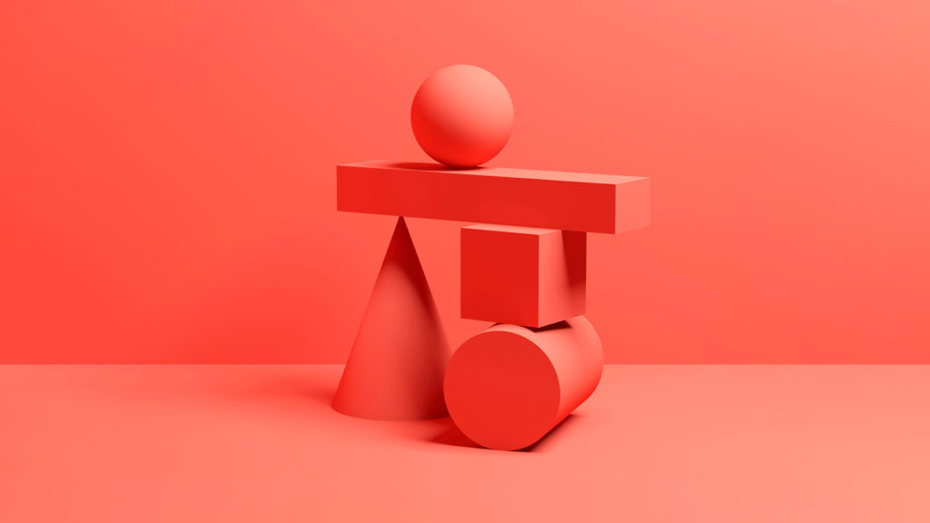 Red geometric shapes, a sphere, cube, cone and cylinder, balanced on top of each other