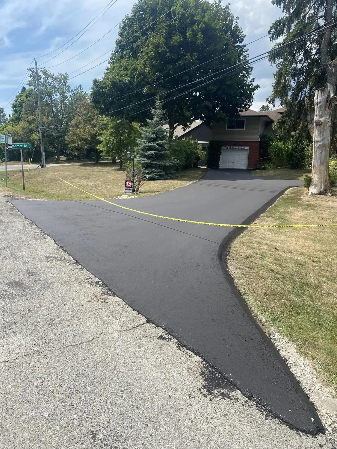 Clean new asphalt apron meeting the existing road