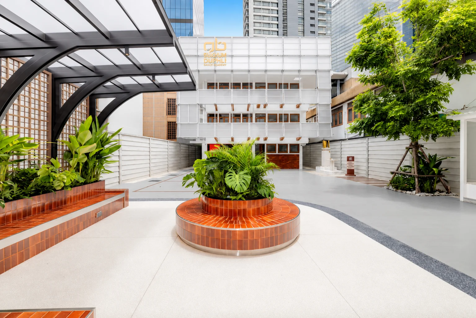 Outdoor common area by daylight, timber screen and planters