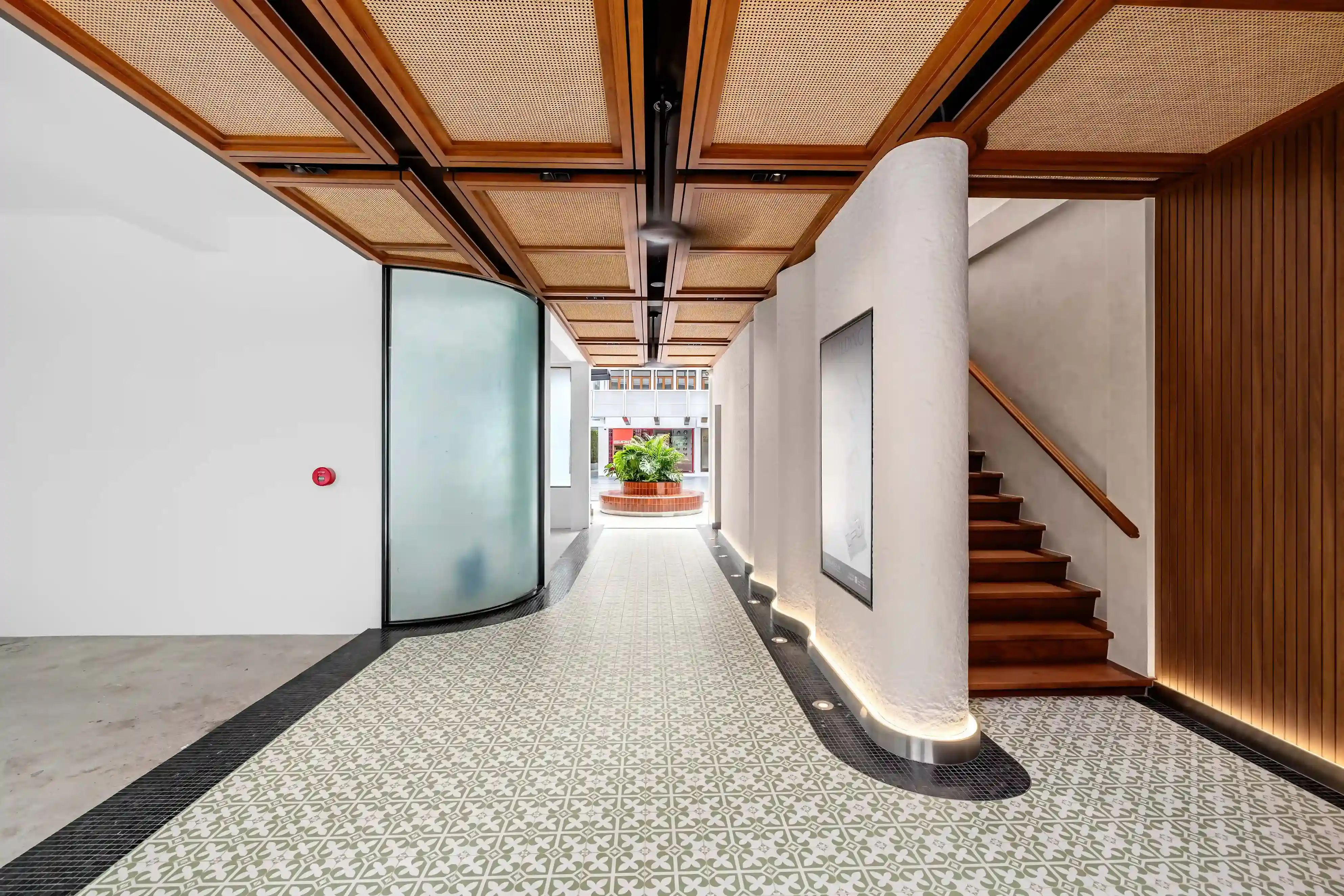 Covered passageway interior, patterned tile floor and rattan ceiling