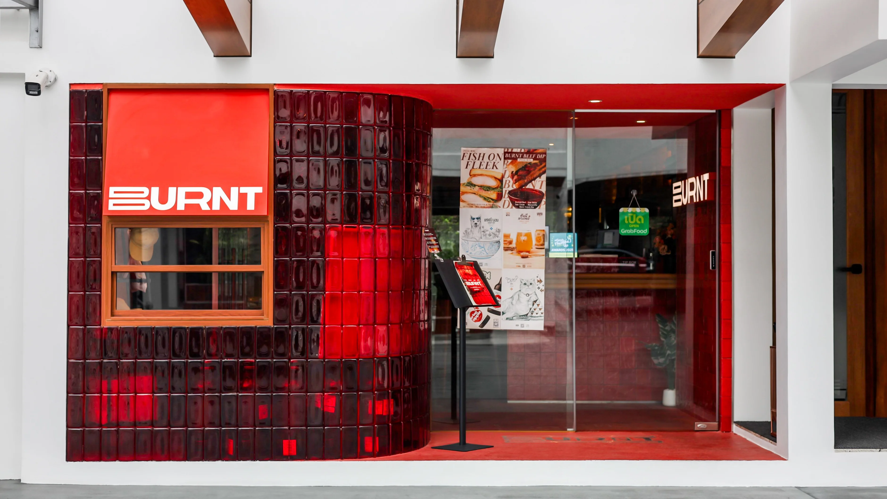 BURNT entrance with red tile and glass doors