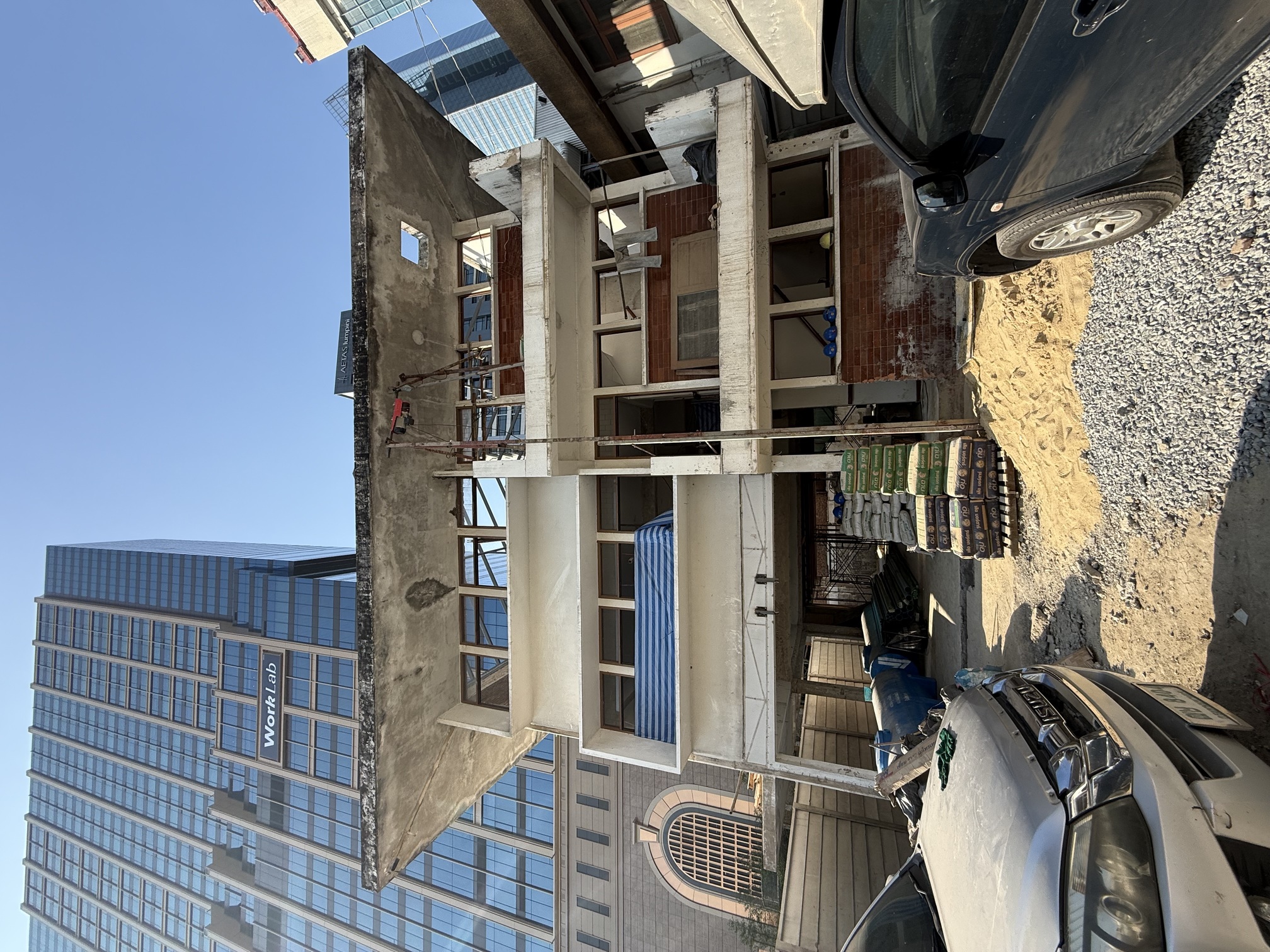 The same facade under construction, bare concrete floors and open window frames
