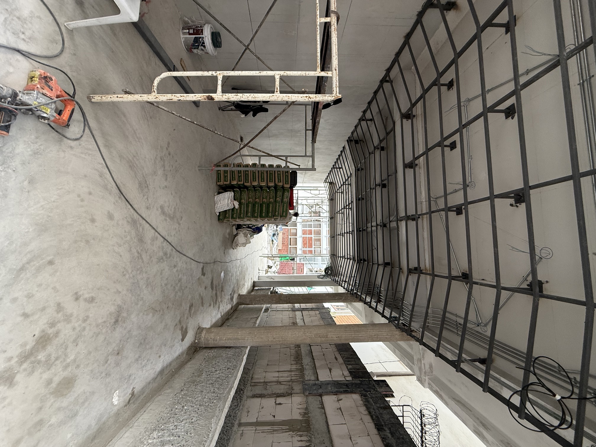 The same passage under construction, a steel grid ceiling and raw concrete walls