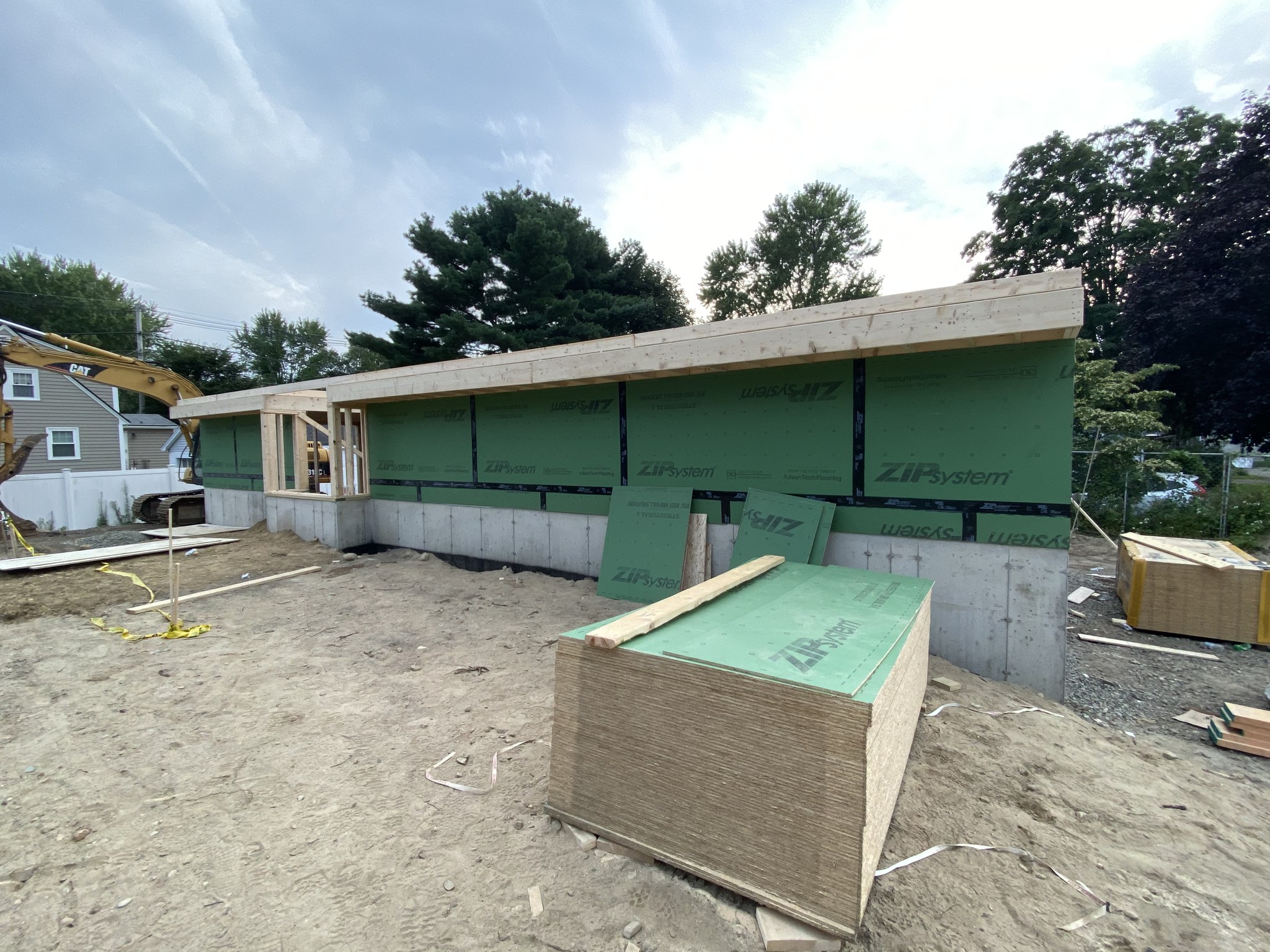First-floor deck framed on the foundation with ZIP System sheathing going up, Wilmington MA
