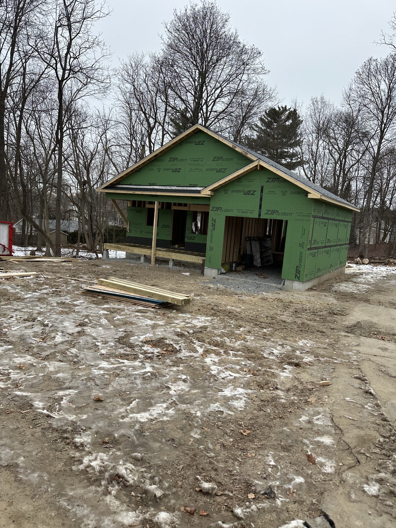 Detached accessory dwelling unit under construction in Dracut, MA, sheathed and roofed with attached garage