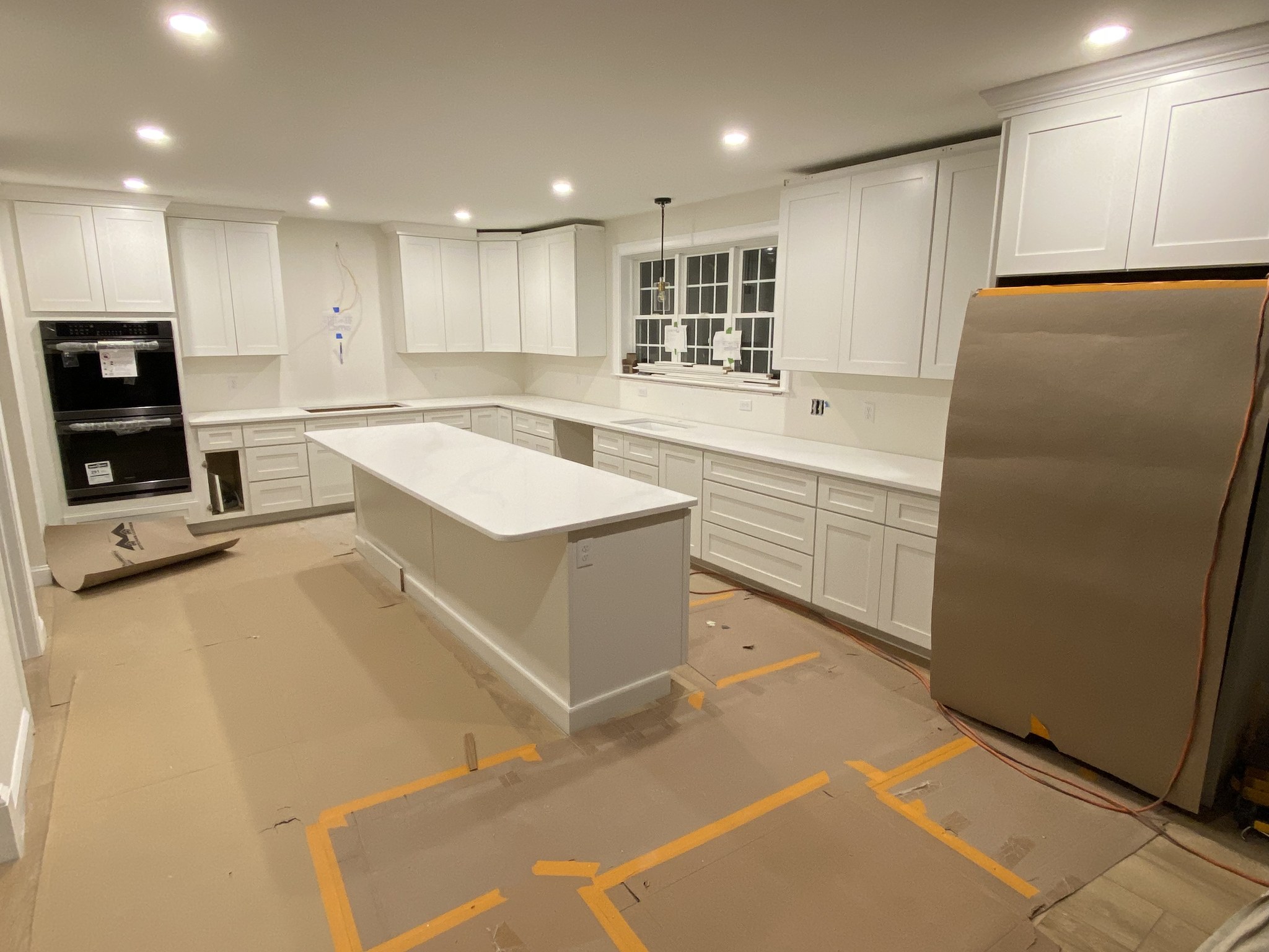 New-construction kitchen with quartz island and white shaker cabinets, Wilmington MA