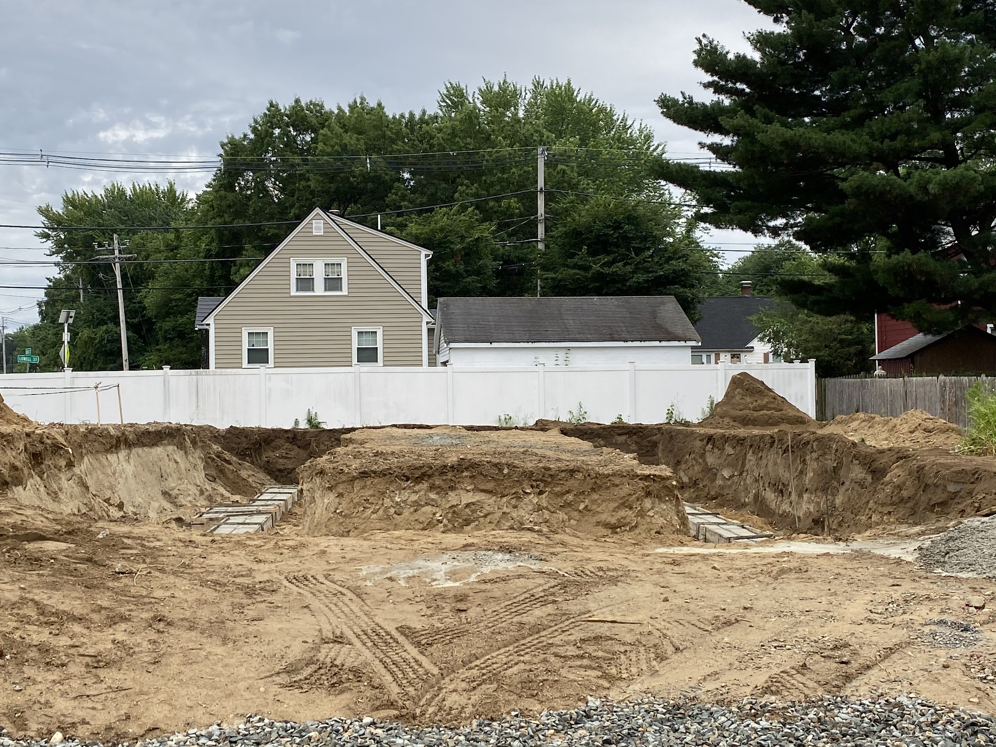 Excavated foundation and poured concrete walls on a new single-family build in Wilmington, MA