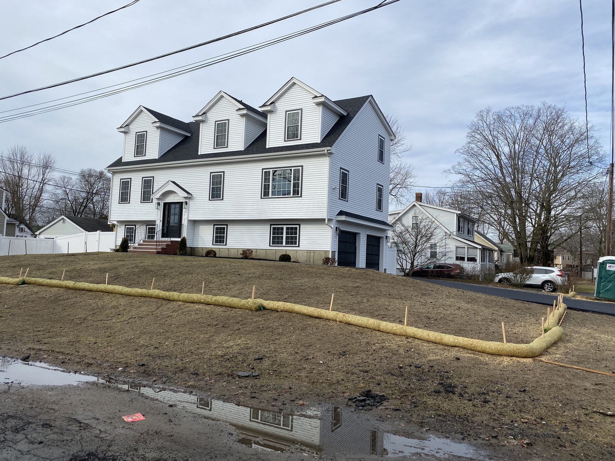 Completed new-construction colonial with dormers and attached garage in Wilmington, MA