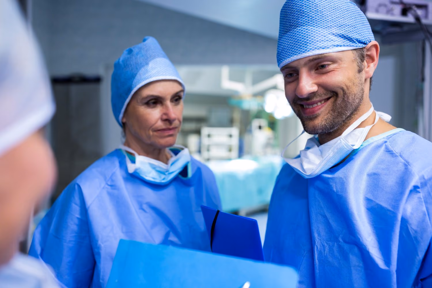 Two surgeons reviewing a case file together before a list