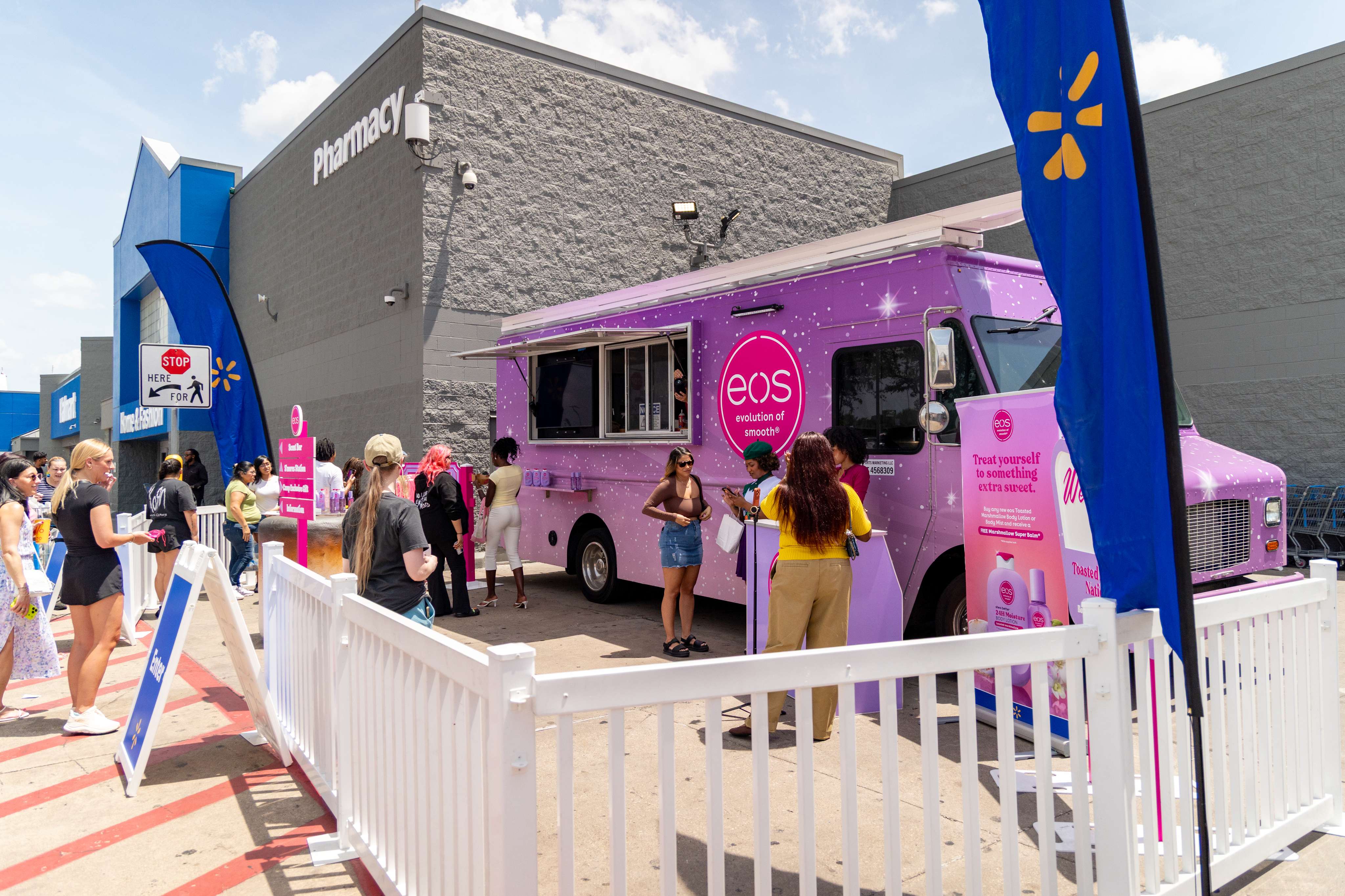 The eos truck parked and open outside Walmart, inside the same fenced footprint