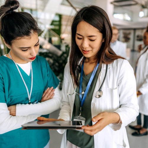 Healthcare professionals talking in a hospital corridor