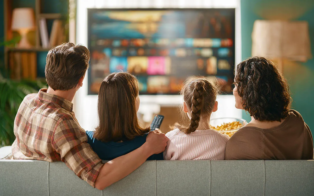 Family watching streaming television at home