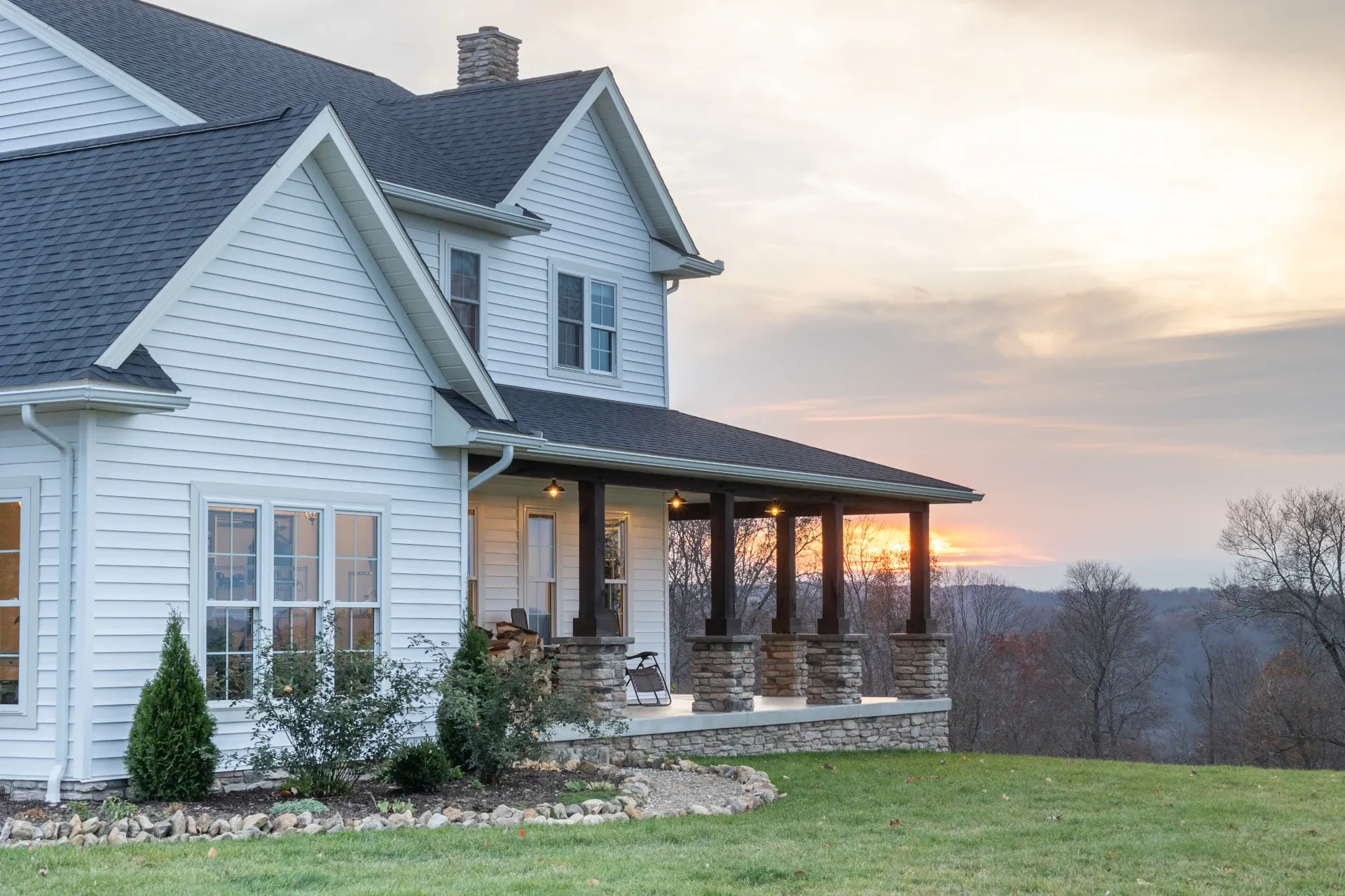 home with outdoor porch during sunset