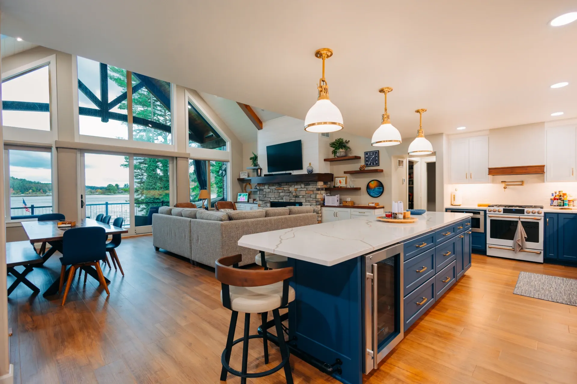 open floor plan with large windows and hardwood flooring