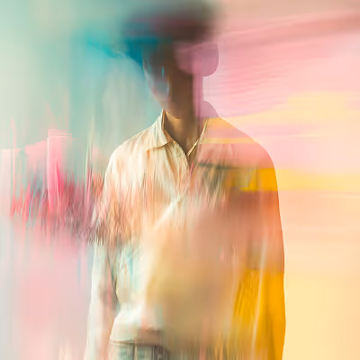 Blurred figure of a person wearing a hat and white shirt against a colorful abstract background.