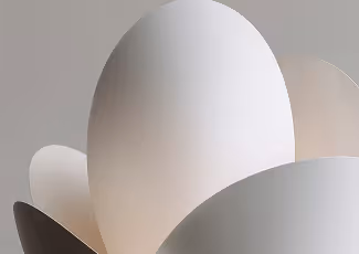 Close-up of smooth, curved white and beige shapes forming an abstract sculpture.