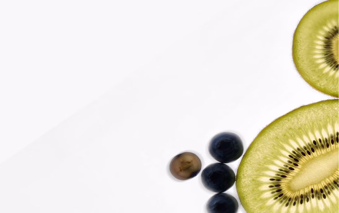 Close-up of two sliced kiwi halves and a cluster of five grapes on a white background.