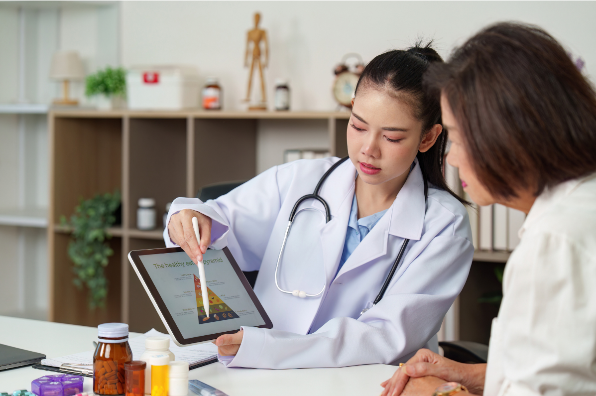 Doctor reviewing results on a tablet with a patient