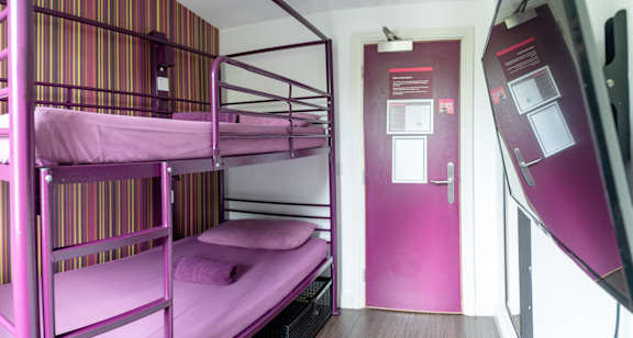 Bunk bed beside a window