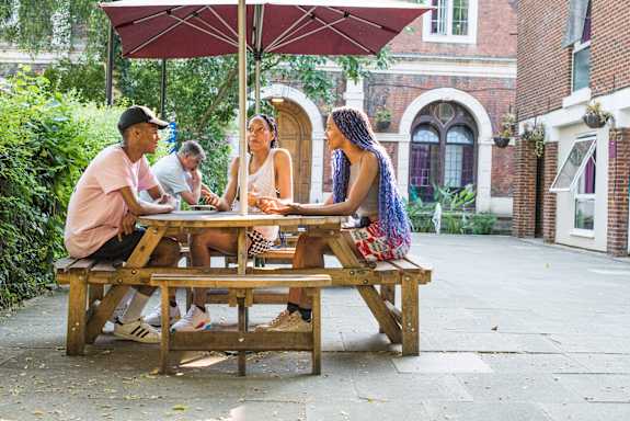 Travellers at the courtyard picnic table