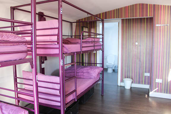 Shared dormitory with bunks and windows