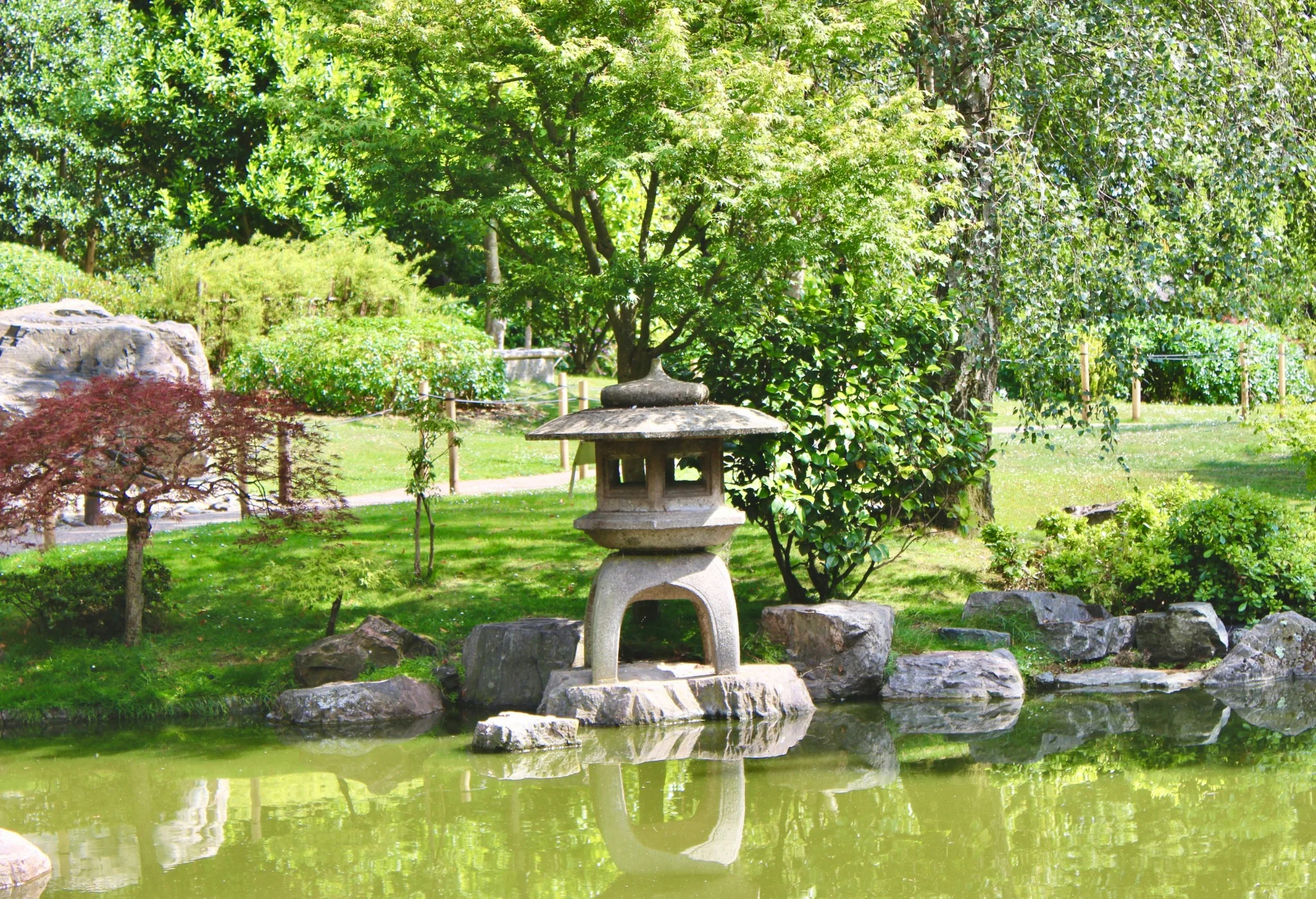 Stone lantern beside the pond in Kyoto Garden