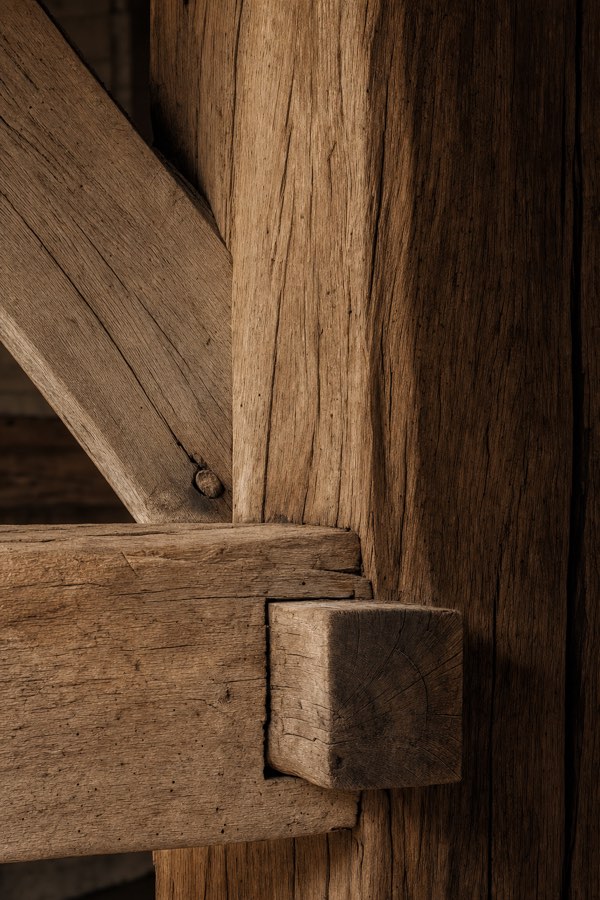 A weathered oak mortise-and-tenon joint, pegged and squared.
