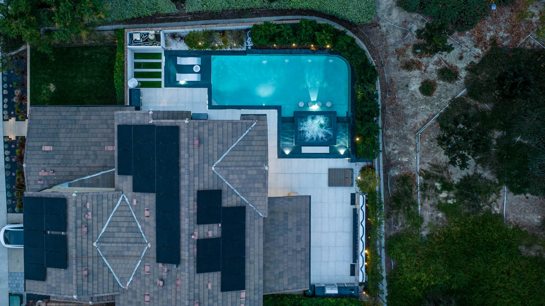The property from overhead, the pool and spa set into the terrace beside the house.