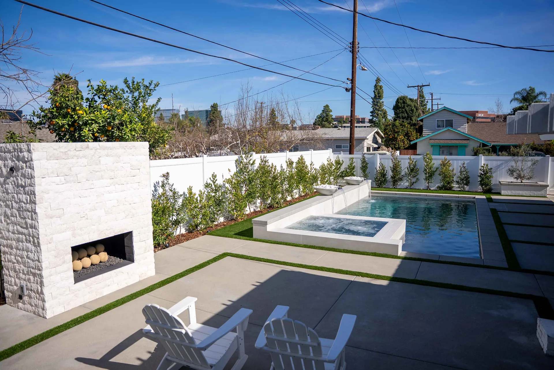 The fireplace tower standing at the corner of the deck, with the pool and spa running away behind it.
