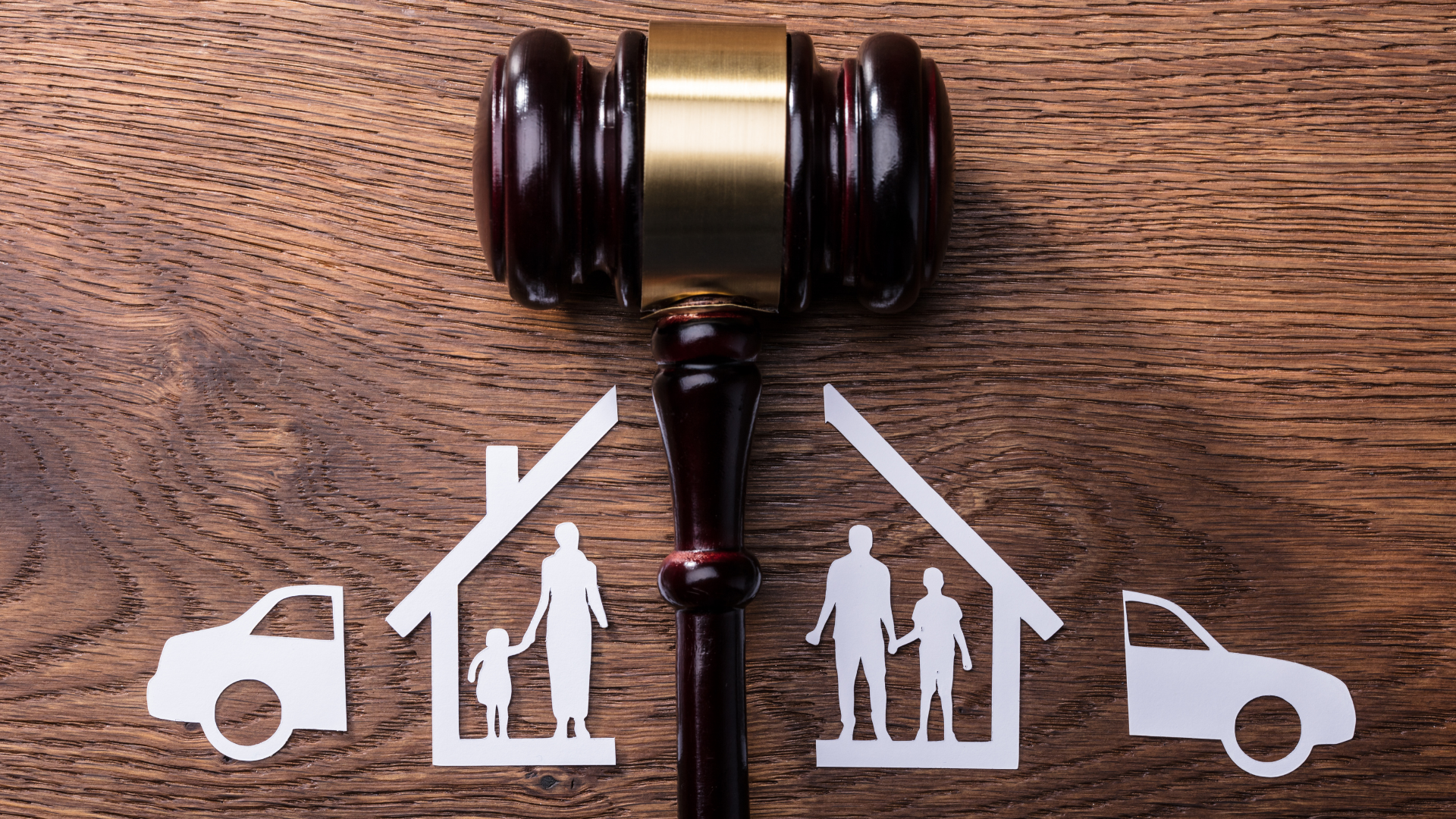 Gavel above white house and car icons, symbolizing legal custody or property dispute.