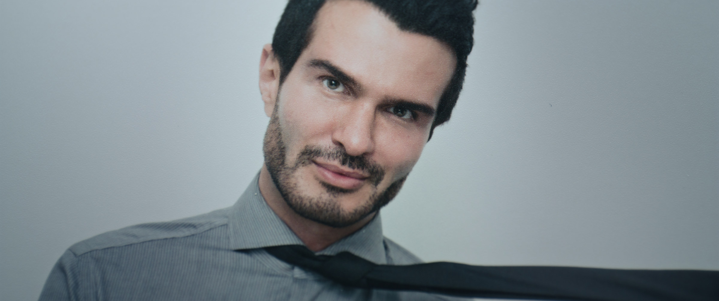 The Abnormal Beauty Company: archival portrait of a man loosening his tie