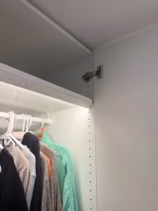 Inside view of IKEA PAX wardrobe installation in Vancouver showing hanging clothes and storage space