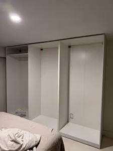 Full interior view of custom-installed IKEA PAX wardrobe in Vancouver with organized shelving and hanging space