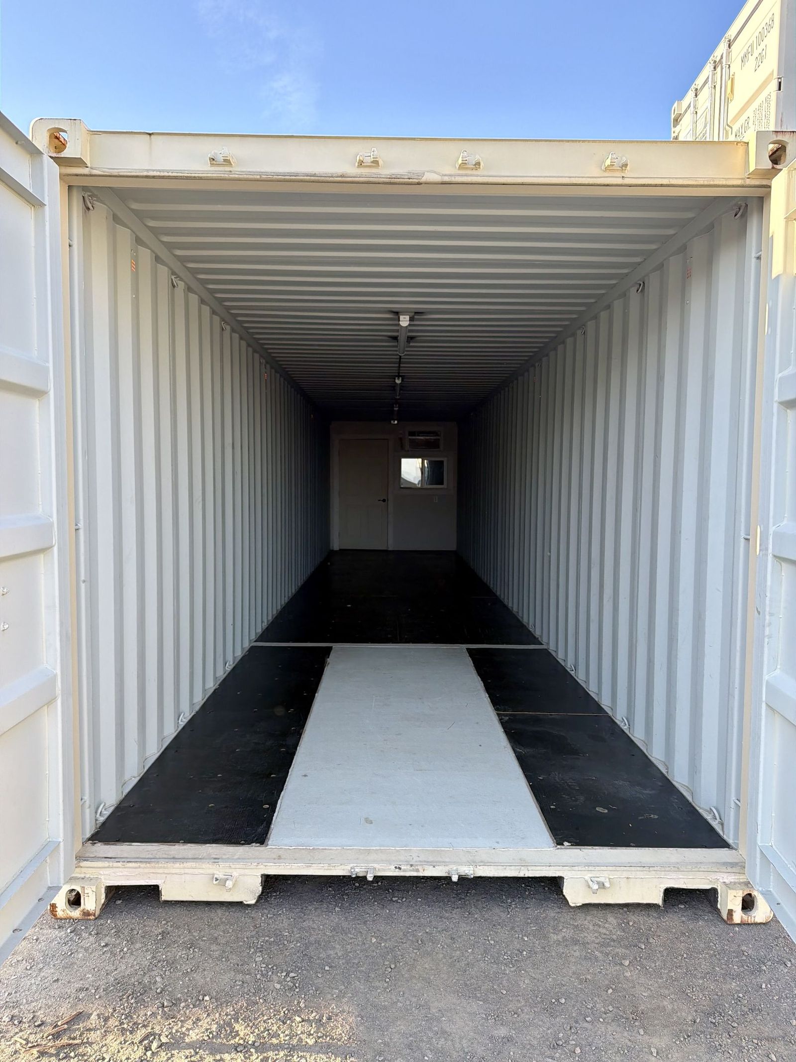 Slate grey forty foot container office with three windows and a personnel door along one side