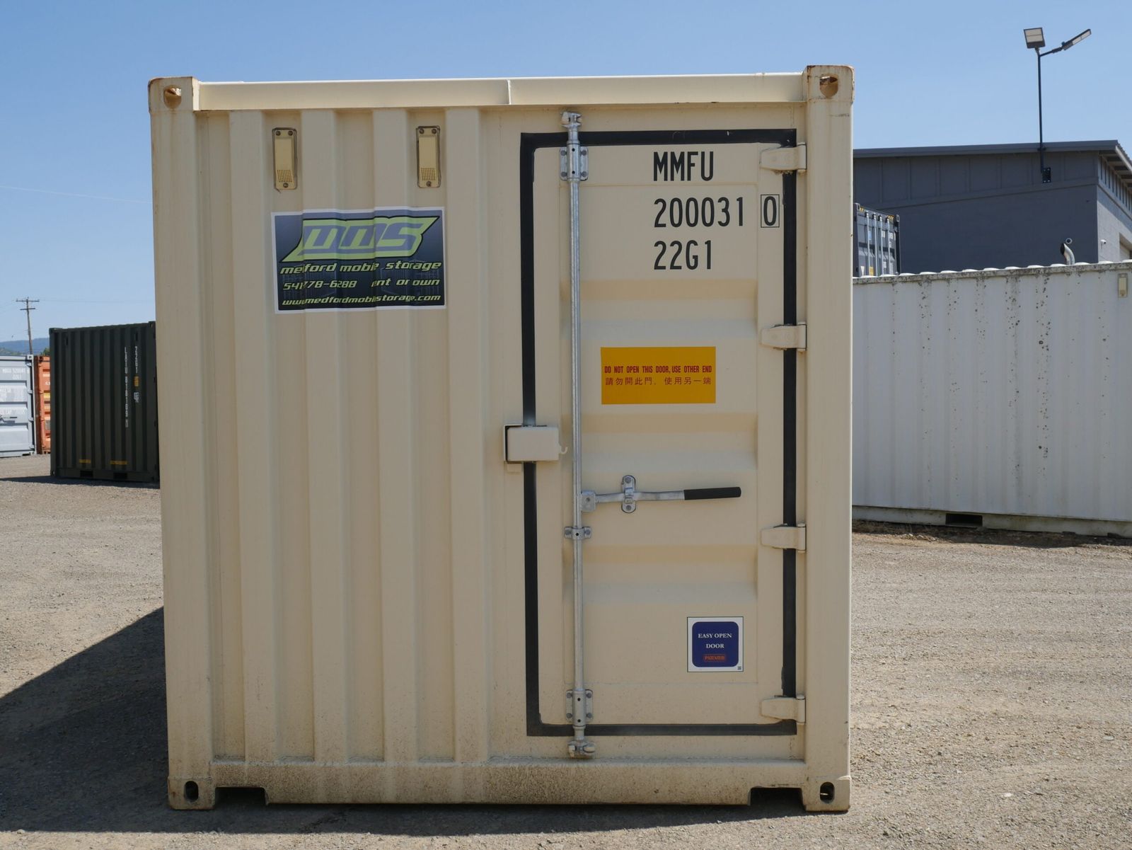 Delivery truck maneuvering a container into a yard space