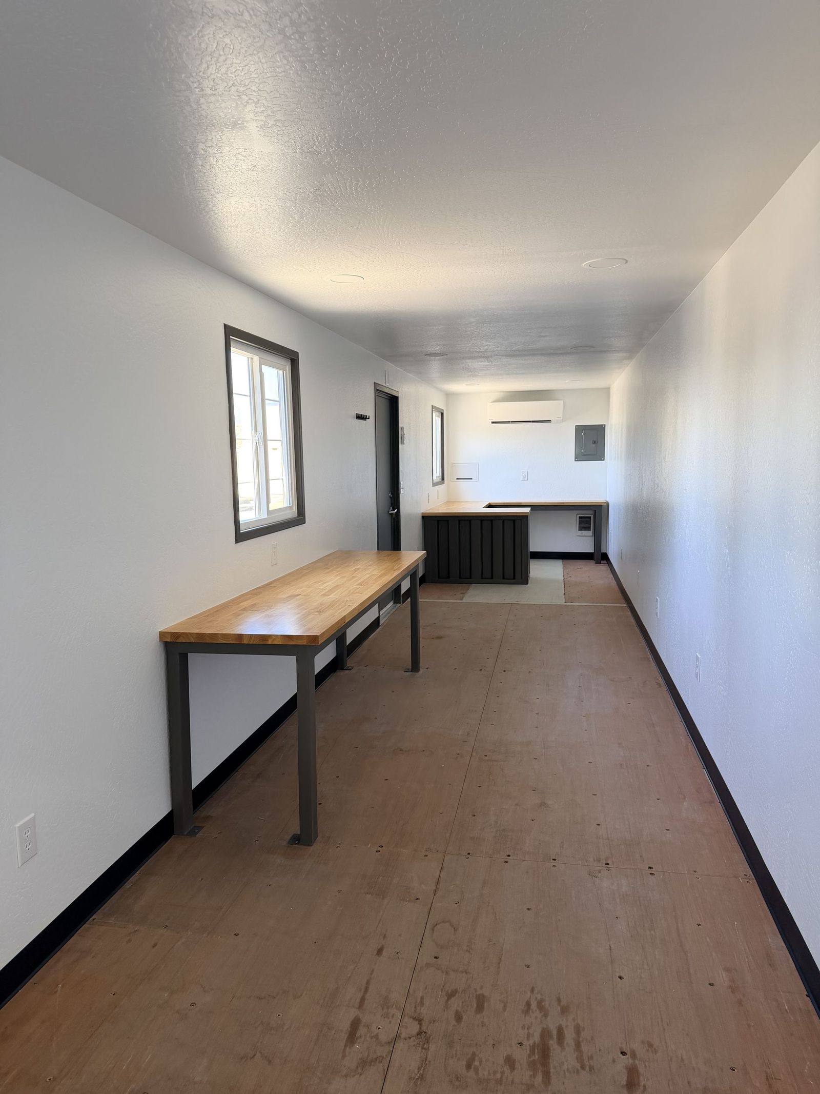 Forty foot semi office container with open storage in front and an enclosed office at the far end