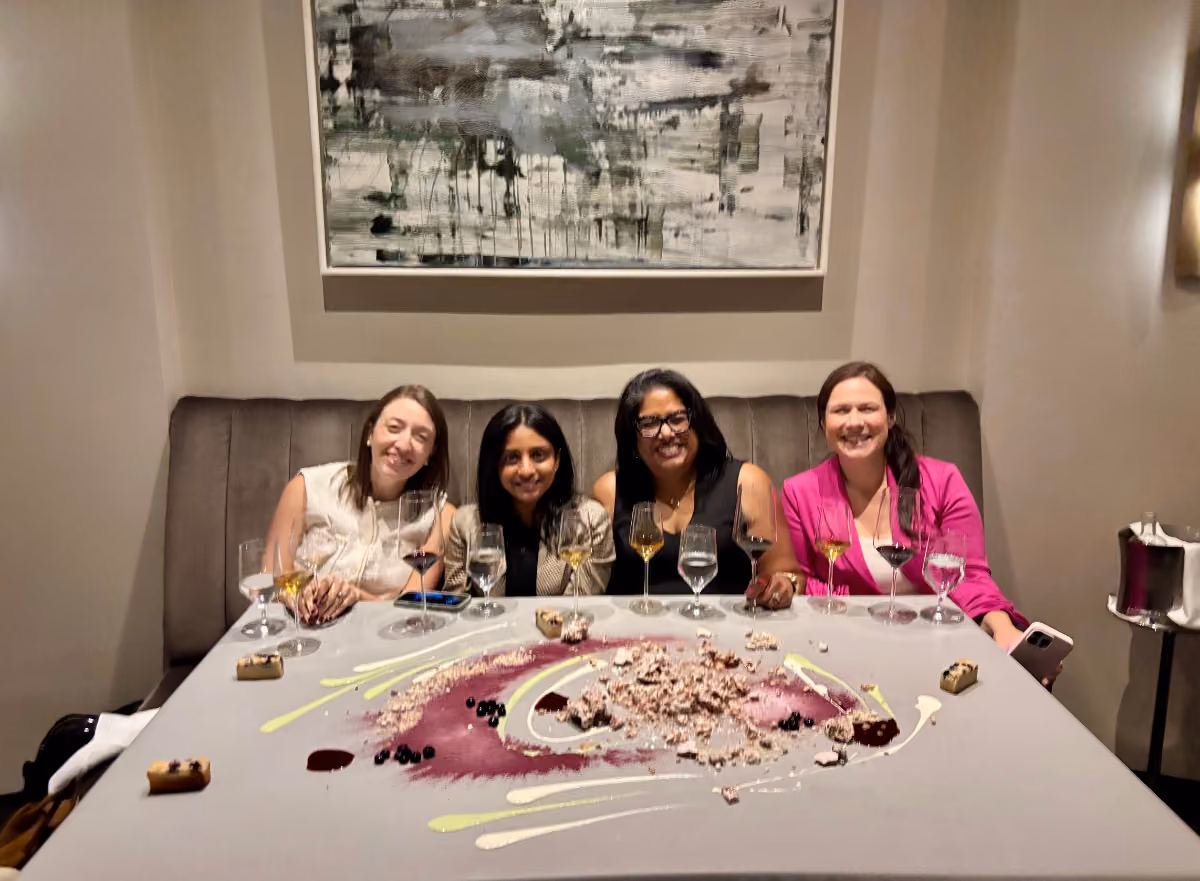 Four women enjoy a networking dinner at Alinea together after the Women in B2B event, sharing dessert and conversation.