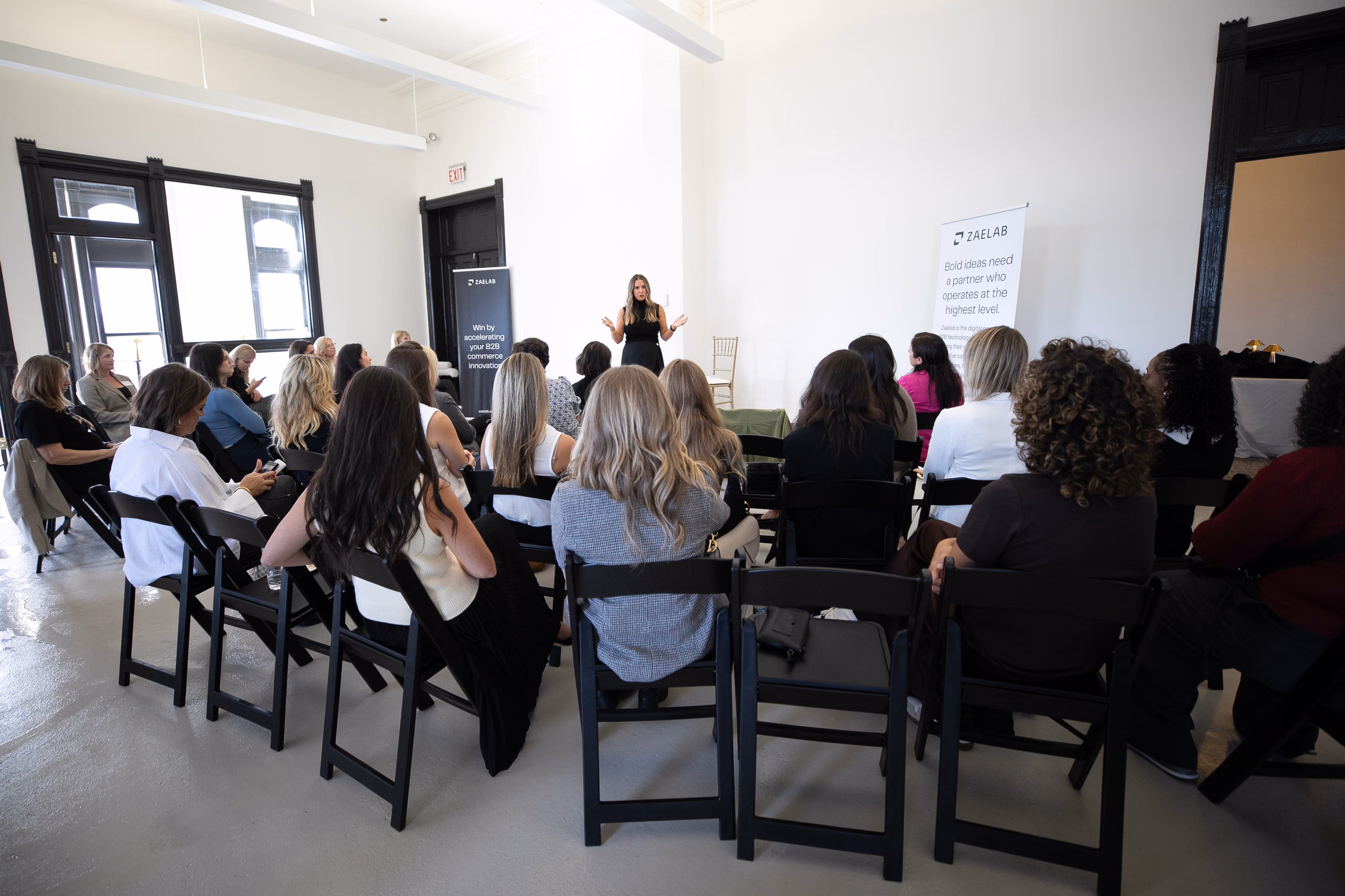 A motivational speaker addresses a seated audience during the Women in B2B Thought Leadership Collective, hosted by Zaelab.