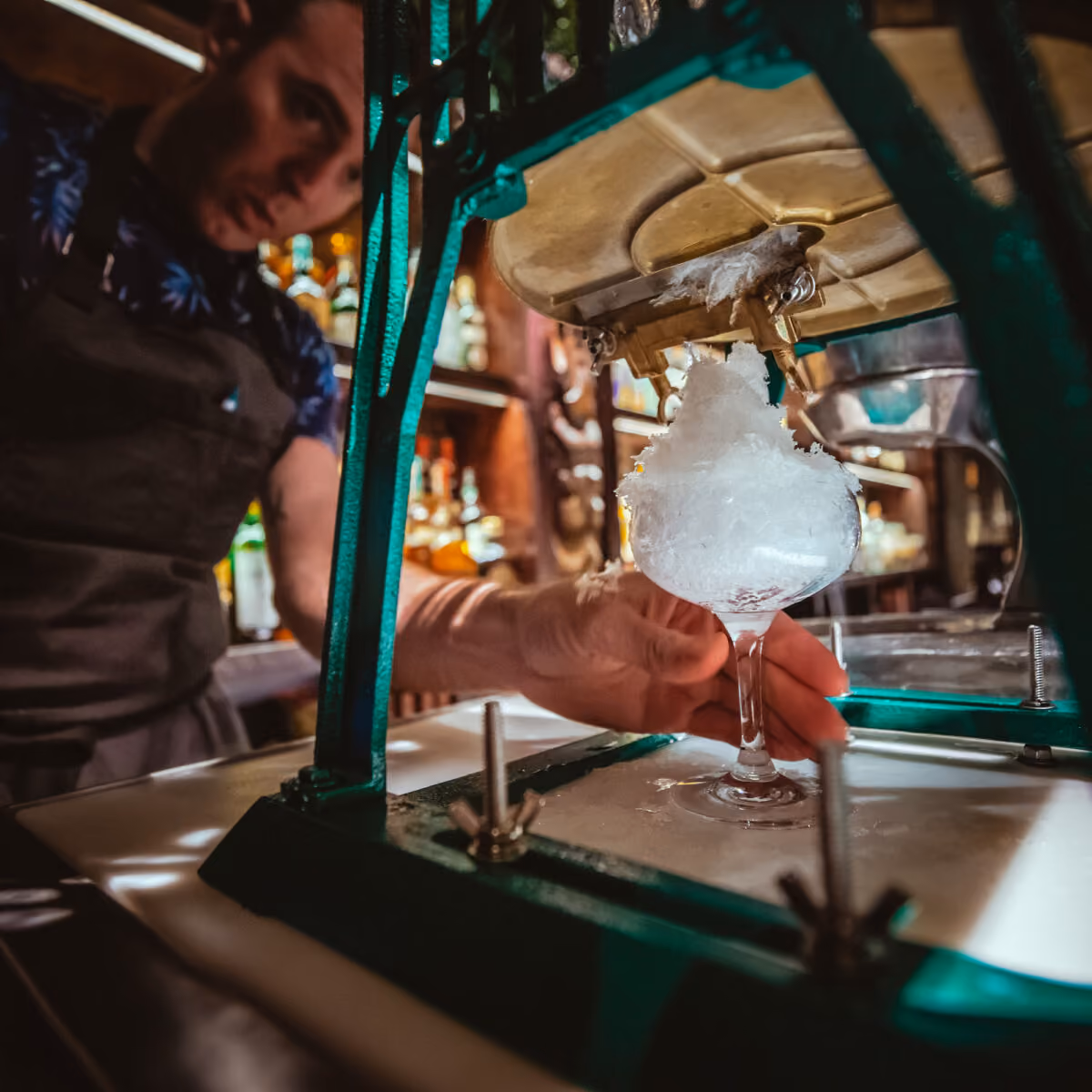 Bartender at Three Dots and a Dash making a cocktail