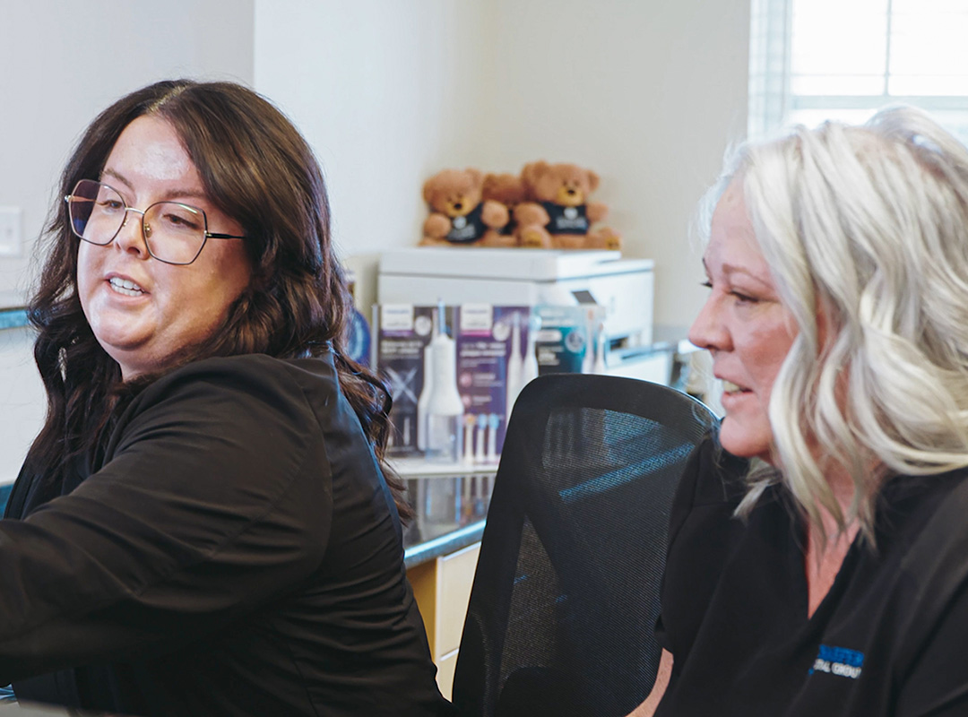 Schaefer Dental Group team members working together in a treatment room at the Brighton, MI dental office.