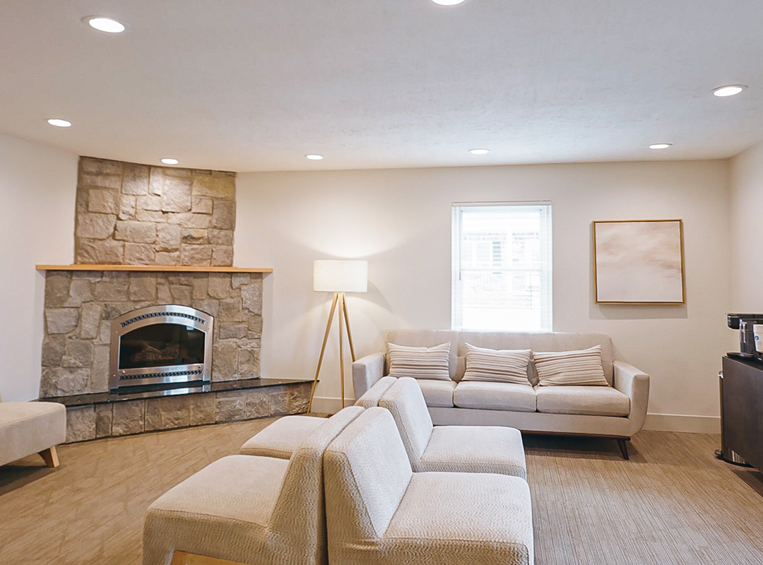 Comfortable patient waiting area with fireplace and seating at Schaefer Dental Group in Brighton, MI.