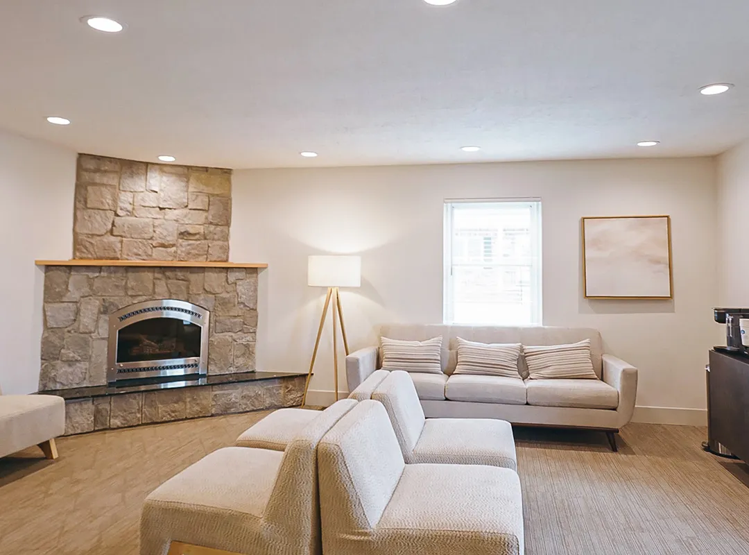     Comfortable patient waiting area with fireplace and seating at Schaefer Dental Group in Brighton, MI.