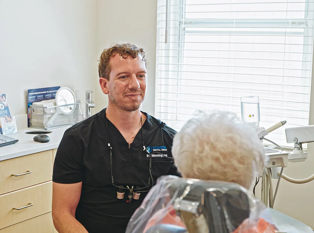 Brighton dentist speaking with a patient in the treatment room at Schaefer Dental Group.