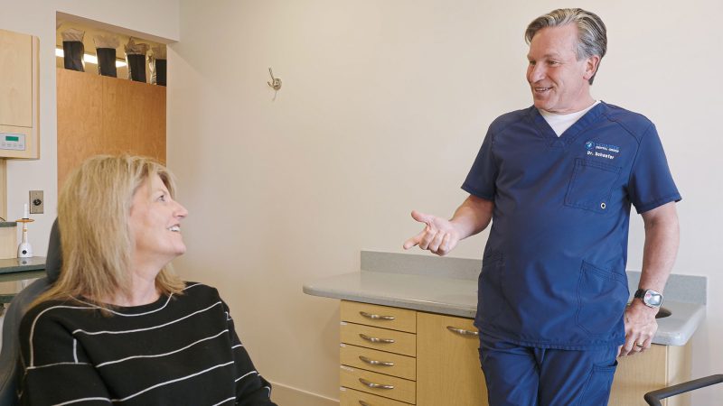 Brighton, MI dentist discussing dental care with a patient at Schaefer Dental Group.